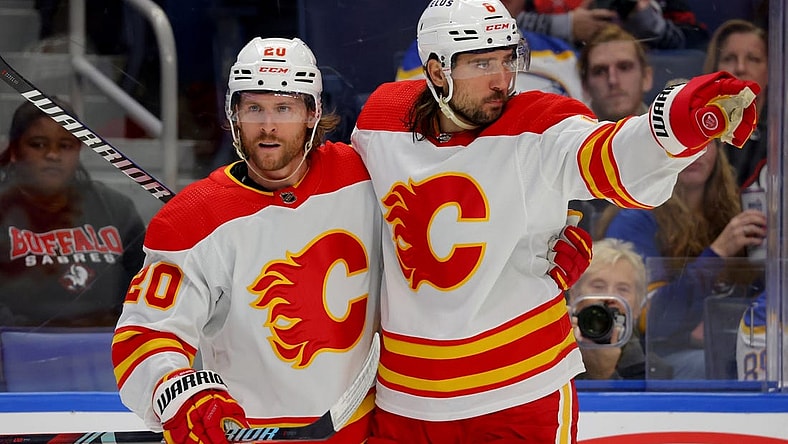 Oct 19, 2023; Buffalo, New York, USA;  Calgary Flames center Blake Coleman (20) celebrates his goal with defenseman Chris Tanev (8) during the third period against the Buffalo Sabres at KeyBank Center. Mandatory Credit: Timothy T. Ludwig-USA TODAY Sports
