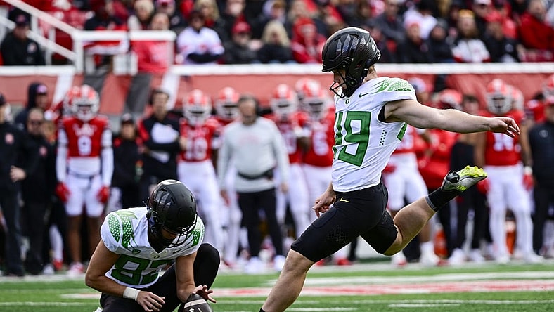 Oct 28, 2023; Salt Lake City, Utah, USA; Oregon Ducks kicker Camden Lewis (49) kicks a PAT against the Utah Utes during the first half at Rice-Eccles Stadium. Mandatory Credit: Christopher Creveling-USA TODAY Sports