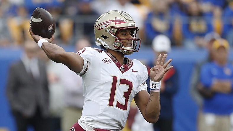 Nov 4, 2023; Pittsburgh, Pennsylvania, USA;  Florida State Seminoles quarterback Jordan Travis (13) passes the ball against the Pittsburgh Panthers during the first quarter at Acrisure Stadium. Mandatory Credit: Charles LeClaire-USA TODAY Sports