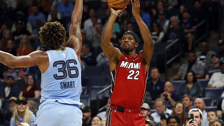 Nov 8, 2023; Memphis, Tennessee, USA; Miami Heat forward Jimmy Butler (22) shoots for three as Memphis Grizzlies guard Marcus Smart (36) defends during the first half at FedExForum. Mandatory Credit: Petre Thomas-USA TODAY Sports