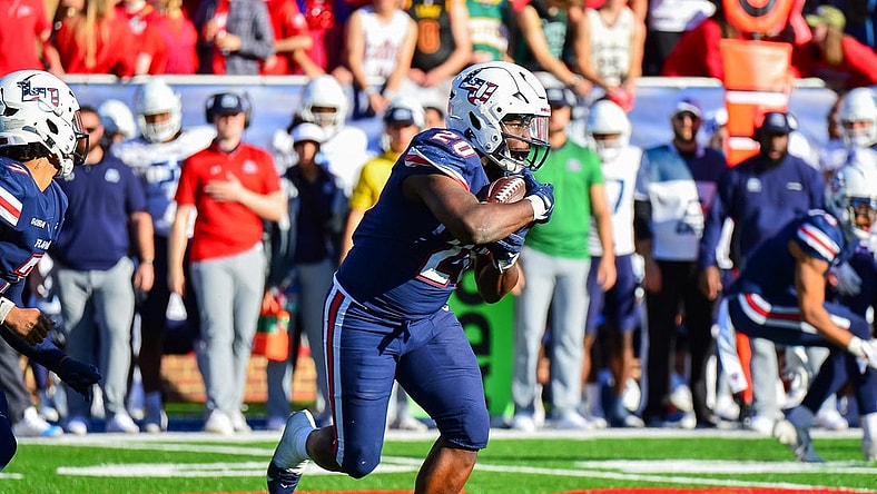 Nov 11, 2023; Lynchburg, Virginia, USA; Liberty Flames running back Quinton Cooley (20) runs the ball in the third quarter at Williams Stadium. Mandatory Credit: Brian Bishop-USA TODAY Sports