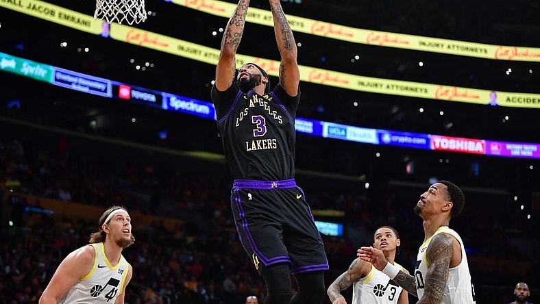 Nov 21, 2023; Los Angeles, California, USA; Los Angeles Lakers forward Anthony Davis (3) moves to the basket ahead of Utah Jazz forward John Collins (20) and forward Kelly Olynyk (41) during the first half at Crypto.com Arena. Mandatory Credit: Gary A. Vasquez-USA TODAY Sports