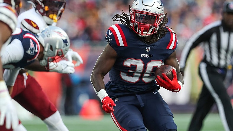 Nov 5, 2023; Foxborough, Massachusetts, USA; New England Patriots running back Rhamondre Stevenson (38) runs the ball during the second half against the Washington Commanders at Gillette Stadium. Mandatory Credit: Paul Rutherford-USA TODAY Sports