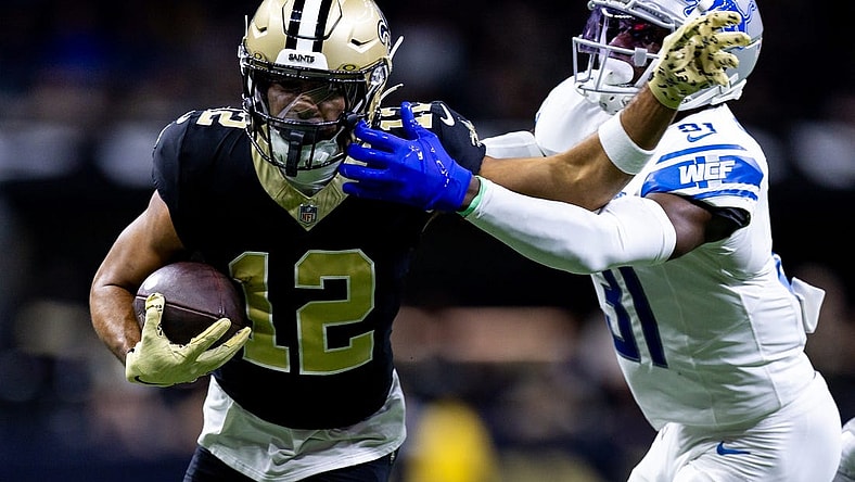Dec 3, 2023; New Orleans, Louisiana, USA; Detroit Lions safety Kerby Joseph (31) tackles New Orleans Saints wide receiver Chris Olave (12) during the first half at the Caesars Superdome. Mandatory Credit: Stephen Lew-USA TODAY Sports