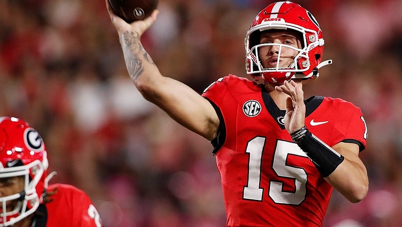 Georgia quarterback Carson Beck (15) throws a touchdown pass to Georgia wide receiver Rara Thomas (5) during the first half of a NCAA college football game against Kentucky in Athens, Ga., on Saturday, Oct. 7, 2023.
