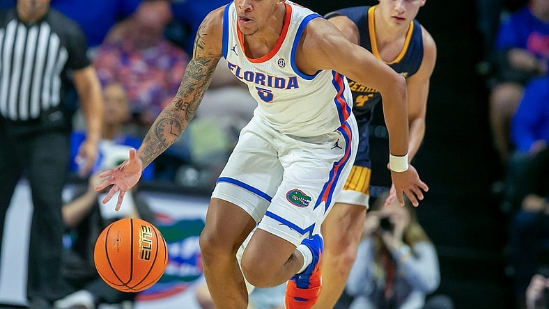 Florida Gators guard Will Richard (5) steals the ball from Merrimack College Jordan Derkack (4) during first half action of an NCAA basketball game as Florida Gators take on Merrimack College Warrors at Exactech Areana in Gainesville, FL on Tuesday, December 5, 2023. [Alan Youngblood/Gainesville Sun]