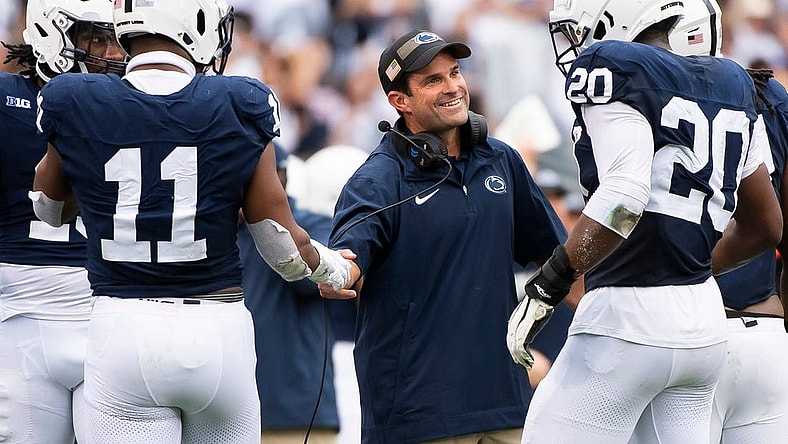 Penn State defensive coordinator Manny Diaz grins as his unit comes to the sideline after creating a turnover late in the the second half of an NCAA football game against Indiana at Beaver Stadium Saturday, Oct. 28, 2023, in State College, Pa.