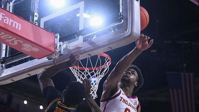 Dec 10, 2023; Los Angeles, California, USA; USC Trojans guard Bronny James (6) blocks a shot by Long Beach State 49ers guard Jadon Jones (12) in the first half at Galen Center. It was James first game of the season since suffering a near fatal heat attack. Mandatory Credit: Robert Hanashiro-USA TODAY Sports