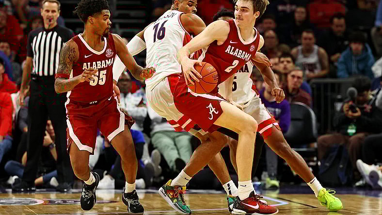 Dec 20, 2023; Phoenix, Arizona, USA; Alabama Crimson Tide forward Grant Nelson (2) handles the ball against Arizona Wildcats forward Keshad Johnson (16) during the second half in the Hall of Fame Series at Footprint Center. Mandatory Credit: Mark J. Rebilas-USA TODAY Sports
