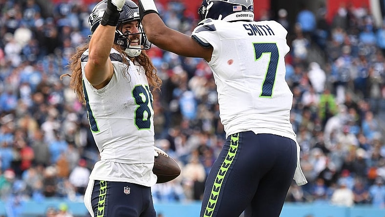 Dec 24, 2023; Nashville, Tennessee, USA; Seattle Seahawks tight end Colby Parkinson (84) celebrates with quarterback Geno Smith (7) after scoring the game-winning touchdown during the second half against the Tennessee Titans at Nissan Stadium. Mandatory Credit: Christopher Hanewinckel-USA TODAY Sports