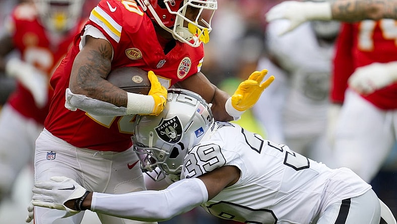 Dec 25, 2023; Kansas City, Missouri, USA; Kansas City Chiefs running back Isiah Pacheco (10) runs the ball against Las Vegas Raiders cornerback Nate Hobbs (39) during the first half at GEHA Field at Arrowhead Stadium. Mandatory Credit: Jay Biggerstaff-USA TODAY Sports