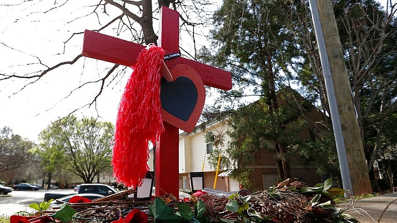 A memorial at the crash site were UGA football player Devin Willock and UGA staffer Chandler LeCroy died in a car crash on Barnett Shoals Road in Athens.