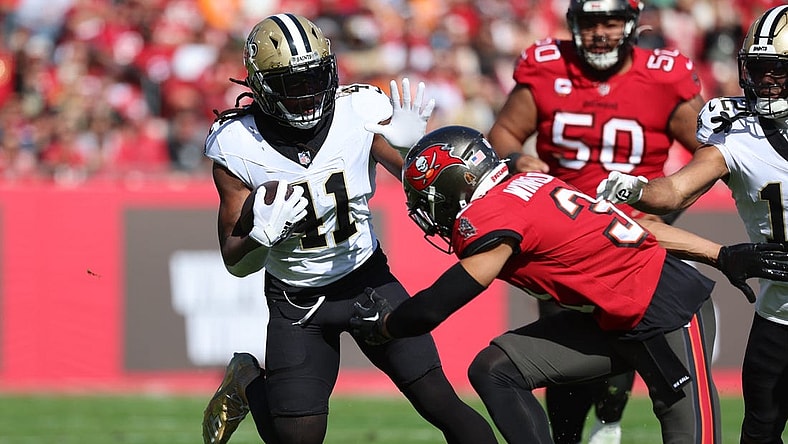 Dec 31, 2023; Tampa, Florida, USA;New Orleans Saints running back Alvin Kamara (41) stiff arms Tampa Bay Buccaneers safety Antoine Winfield Jr. (31) during the first quarter at Raymond James Stadium. Mandatory Credit: Kim Klement Neitzel-USA TODAY Sports