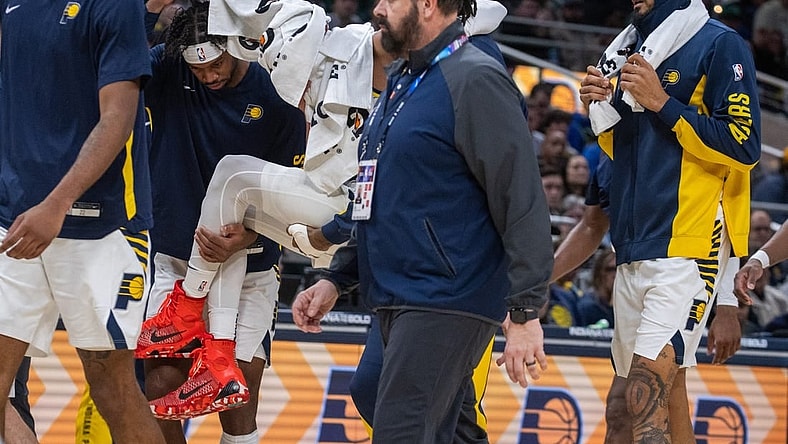 Jan 8, 2024; Indianapolis, Indiana, USA; Indiana Pacers guard Tyrese Haliburton (0) is carried off the court with apparent leg injury in the first half at Gainbridge Fieldhouse. Mandatory Credit: Trevor Ruszkowski-USA TODAY Sports