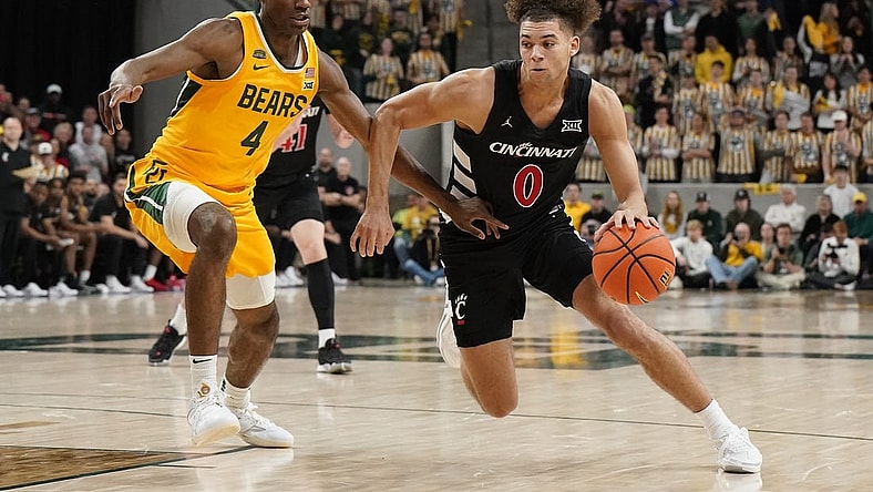 Jan 13, 2024; Waco, Texas, USA; Cincinnati Bearcats guard Dan Skillings Jr. (0) works around Baylor Bears guard Ja'Kobe Walter (4) during the first half at Paul and Alejandra Foster Pavilion. Mandatory Credit: Raymond Carlin III-USA TODAY Sports