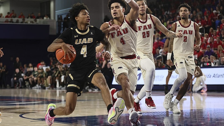 Jan 14, 2024; Boca Raton, Florida, USA; UAB Blazers guard Eric Gaines (4) drives to the basket against Florida Atlantic Owls guard Bryan Greenlee (4) during the first half at Eleanor R. Baldwin Arena. Mandatory Credit: Sam Navarro-USA TODAY Sports