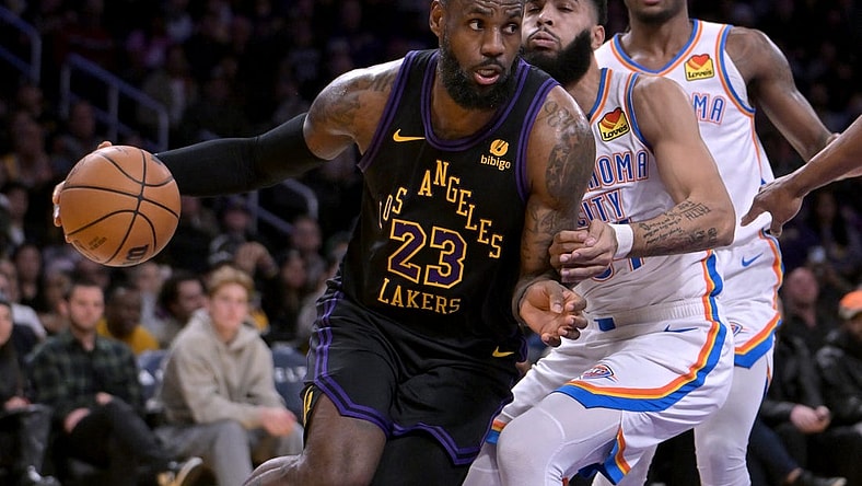 Jan 15, 2024; Los Angeles, California, USA;   Los Angeles Lakers forward LeBron James (23) drives past Oklahoma City Thunder guard Cason Wallace (22) in the first half at Crypto.com Arena. Mandatory Credit: Jayne Kamin-Oncea-USA TODAY Sports