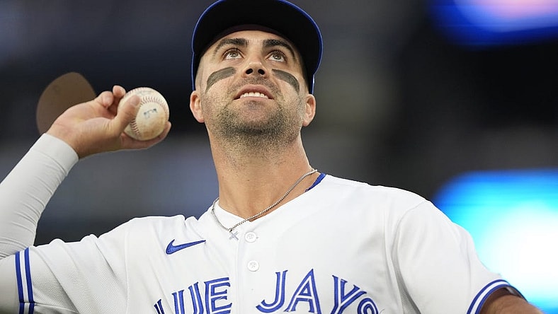 Sep 8, 2023; Toronto, Ontario, CAN; Toronto Blue Jays second baseman Whit Merrifield (15) goes to throw a ball to a fan during the second inning against the Kansas City Royals at Rogers Centre. Mandatory Credit: John E. Sokolowski-USA TODAY Sports