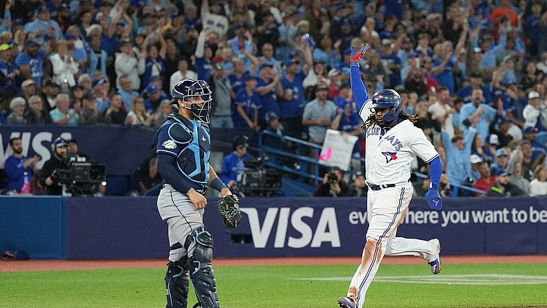 Sep 29, 2023; Toronto, Ontario, CAN; Toronto Blue Jays first baseman Vladimir Guerrero Jr. (27) runs to home plate scoring a run against the Tampa Bay Rays during the sixth inning at Rogers Centre. Mandatory Credit: Nick Turchiaro-USA TODAY Sports