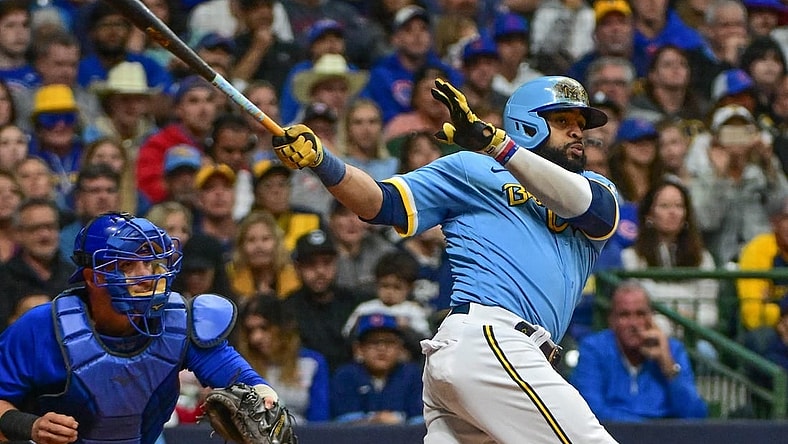 Sep 29, 2023; Milwaukee, Wisconsin, USA;  Milwaukee Brewers first baseman Carlos Santana (41) hits a RBI triple against the Chicago Cubs in the fifth inning at American Family Field. Mandatory Credit: Benny Sieu-USA TODAY Sports