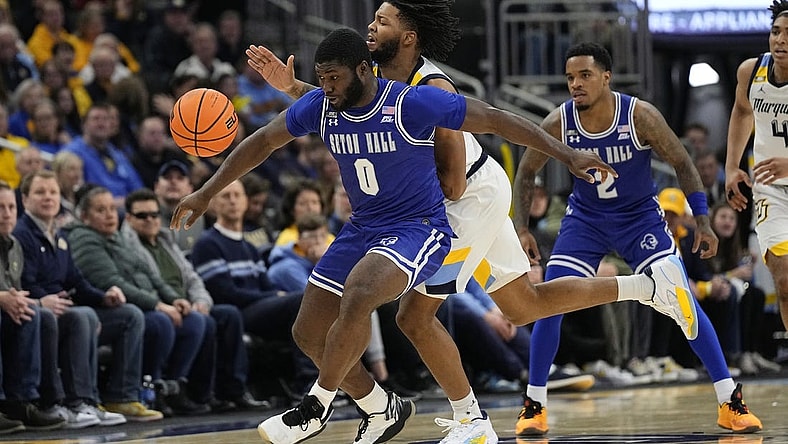 Jan 27, 2024; Milwaukee, Wisconsin, USA; Seton Hall Pirates guard Dylan Addae-Wusu (0) and Marquette Golden Eagles forward David Joplin (23) chase the loose ball during the second half at Fiserv Forum. Mandatory Credit: Jeff Hanisch-USA TODAY Sports