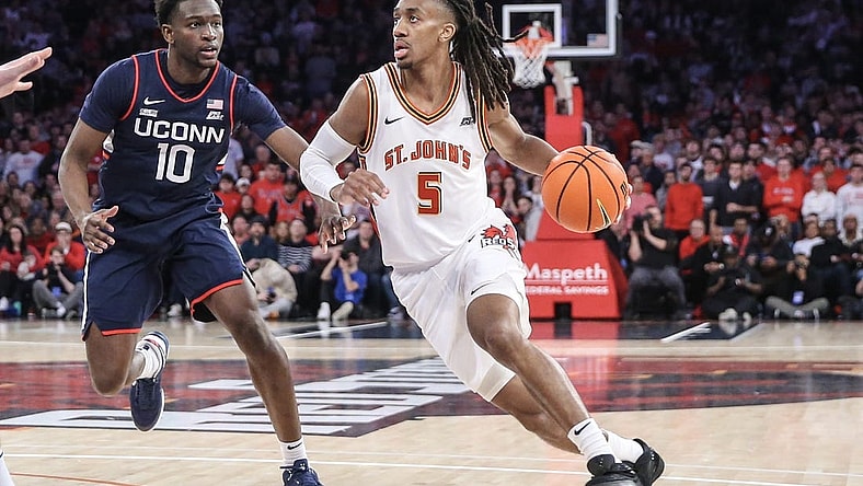 Feb 3, 2024; New York, New York, USA; St. John's Red Storm guard Daniss Jenkins (5) drives past Connecticut Huskies guard Hassan Diarra (10) in the second half at Madison Square Garden. Mandatory Credit: Wendell Cruz-USA TODAY Sports