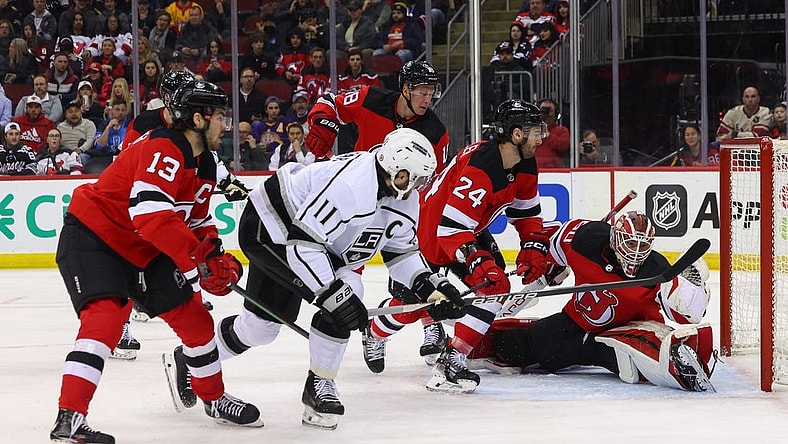 Feb 15, 2024; Newark, New Jersey, USA; New Jersey Devils goaltender Nico Daws (50) makes a glove save on Los Angeles Kings center Anze Kopitar (11) during the first period at Prudential Center. Mandatory Credit: Ed Mulholland-USA TODAY Sports