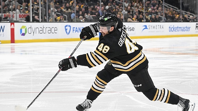 Feb 15, 2024; Boston, Massachusetts, USA; Boston Bruins defenseman Matt Grzelcyk (48) shoots the puck against the Seattle Kraken during the third period at the TD Garden. Mandatory Credit: Brian Fluharty-USA TODAY Sports