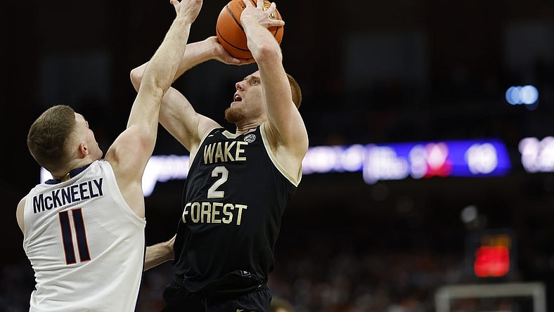 Feb 17, 2024; Charlottesville, Virginia, USA; Wake Forest Demon Deacons guard Cameron Hildreth (2) shoots the ball as Virginia Cavaliers guard Isaac McKneely (11) defends in the first half at John Paul Jones Arena. Mandatory Credit: Geoff Burke-USA TODAY Sports
