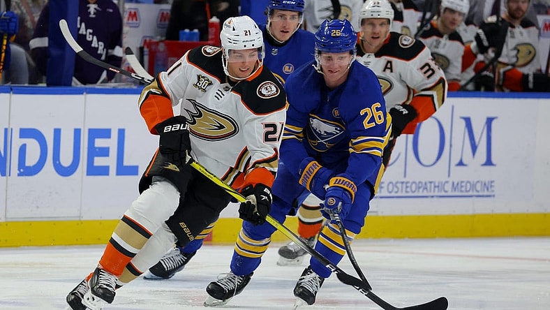 Feb 19, 2024; Buffalo, New York, USA; Anaheim Ducks center Isac Lundestrom (21) looks to control the puck as Buffalo Sabres defenseman Rasmus Dahlin (26) defends during the first period at KeyBank Center. Mandatory Credit: Timothy T. Ludwig-USA TODAY Sports