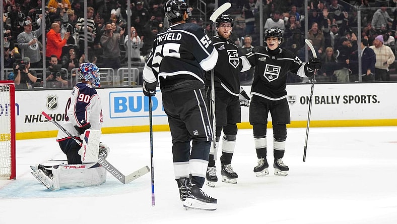 Feb 20, 2024; Los Angeles, California, USA; LA Kings center Pierre-Luc Dubois (80) celebrates after scoring a goal with right wing Quinton Byfield (55) and center Alex Turcotte (38) as Columbus Blue Jackets goaltender Elvis Merzlikins (90) reacts  in the second period at Crypto.com Arena. Mandatory Credit: Kirby Lee-USA TODAY Sports