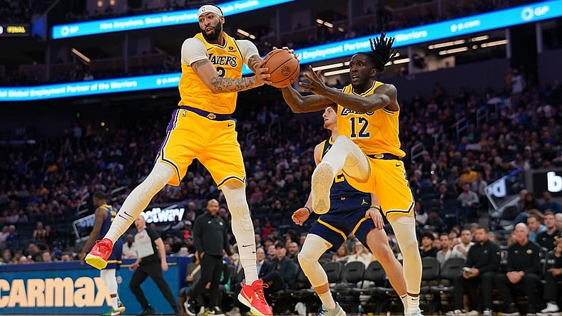 Feb 22, 2024; San Francisco, California, USA; Los Angeles Lakers forward Anthony Davis (3) holds onto a rebound next to forward Taurean Prince (12) against the Golden State Warriors in the third quarter at the Chase Center. Mandatory Credit: Cary Edmondson-USA TODAY Sports