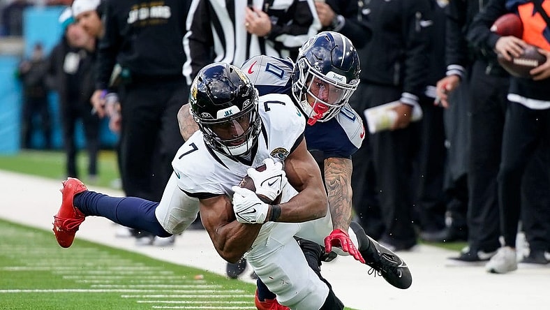 Tennessee Titans cornerback Sean Murphy-Bunting (0) tackles Jacksonville Jaguars wide receiver Zay Jones (7) during the third quarter at Nissan Stadium in Nashville, Tenn., Sunday, Jan. 7, 2024.