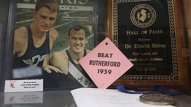 Fair Lawn, NJ -- Feb. 2, 2024 -- A July 1956 cover from Weekly Sports Illustrated features Dave Sime, at left, when he ran track for Duke University.
The trophy case and Hall of Fame Wall at Fair Lawn HS honors one of their alumni, Dave Sime. He was a star athlete at Fair-Lawn in the 1950s, passing away in 2016. He is the grandfather of San Francisco 49ers star running back Christian McCaffrey, who will be playing in the Super Bowl.