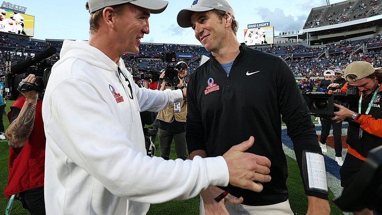 Feb 4, 2024; Orlando, FL, USA; NFC coach Eli Manning and AFC coach Peyton Manning react after the 2024 Pro Bowl at Camping World Stadium. Mandatory Credit: Nathan Ray Seebeck-USA TODAY Sports