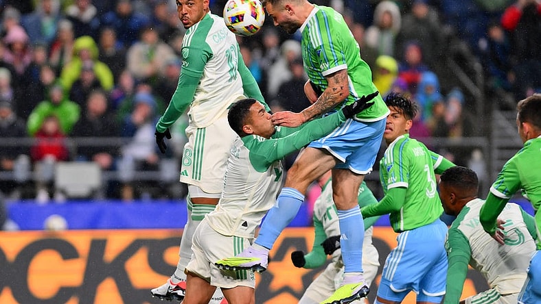 Mar 2, 2024; Seattle, Washington, USA; Seattle Sounders FC forward Jordan Morris (13) heads the ball against Austin FC midfielder Dani Pereira (6) during the first half at Lumen Field. Mandatory Credit: Steven Bisig-USA TODAY Sports