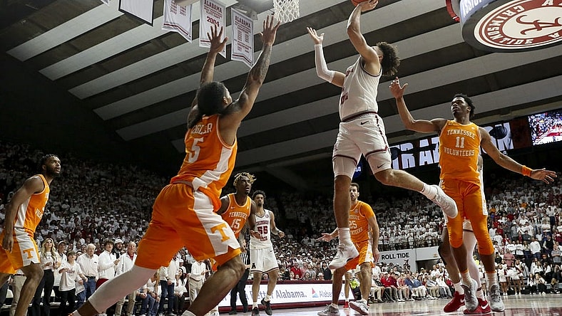 Mar 2, 2024; Tuscaloosa, Alabama, USA; Alabama guard Mark Sears (1) scores in the lane as he is defended by Tennessee guard Zakai Zeigler (5) and Tennessee forward Tobe Awaka (11) at Coleman Coliseum. Mandatory Credit: Gary Cosby Jr.-USA TODAY Sports