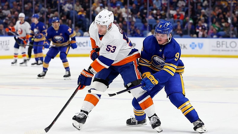Mar 14, 2024; Buffalo, New York, USA;  New York Islanders center Casey Cizikas (53) controls the puck as Buffalo Sabres left wing Zach Benson (9) defends during the second period at KeyBank Center. Mandatory Credit: Timothy T. Ludwig-USA TODAY Sports