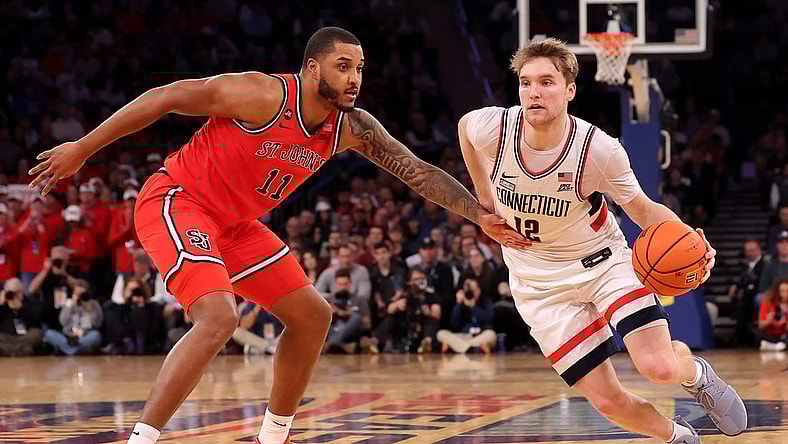 Mar 15, 2024; New York City, NY, USA; Connecticut Huskies guard Cam Spencer (12) drives to the basket against St. John's Red Storm center Joel Soriano (11) during the second half at Madison Square Garden. Mandatory Credit: Brad Penner-USA TODAY Sports