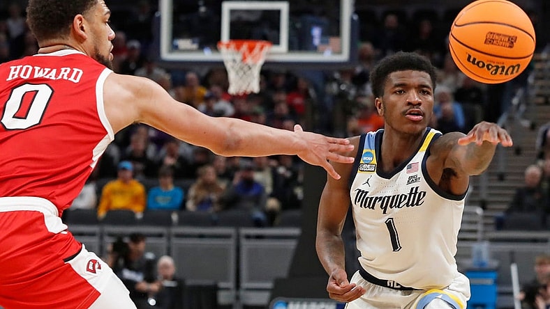 Western Kentucky Hilltoppers forward Rodney Howard (0) defends the pass of Marquette Golden Eagles guard Kam Jones (1) during NCAA Men’s Basketball Tournament game, Friday, March 22, 2024, at Gainbridge Fieldhouse in Indianapolis.