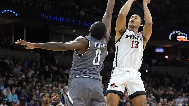 Mar 22, 2024; Spokane, WA, USA; San Diego State Aztecs forward Jaedon LeDee (13) attempts a basket against UAB Blazers forward Javian Davis (0) during the second half in the first round of the 2024 NCAA Tournament at Spokane Veterans Memorial Arena. Mandatory Credit: Kirby Lee-USA TODAY Sports