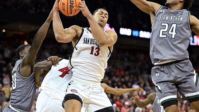 Mar 22, 2024; Spokane, WA, USA; San Diego State Aztecs forward Jaedon LeDee (13) rebounds the ball against UAB Blazers guard Efrem Johnson (24) during the second half in the first round of the 2024 NCAA Tournament at Spokane Veterans Memorial Arena. Mandatory Credit: James Snook-USA TODAY Sports