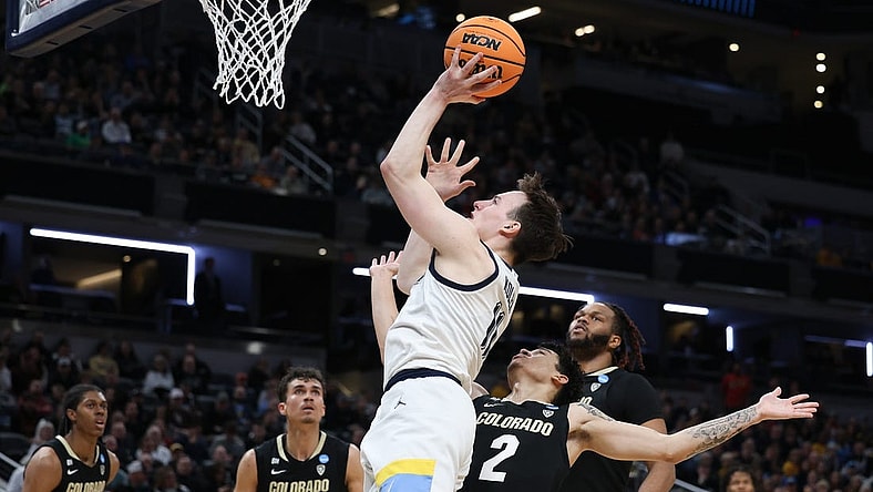 Mar 24, 2024; Indianapolis, IN, USA; Marquette Golden Eagles guard Tyler Kolek (11) shoots over Colorado Buffaloes guard KJ Simpson (2) during the first half at Gainbridge FieldHouse. Mandatory Credit: Trevor Ruszkowski-USA TODAY Sports