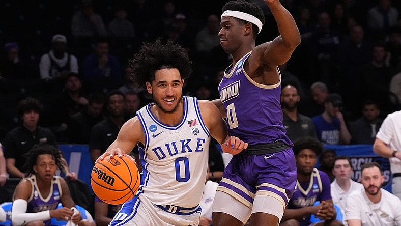 Mar 24, 2024; Brooklyn, NY, USA; Duke Blue Devils guard Jared McCain (0) dribbles the ball past James Madison Dukes guard Xavier Brown (0) in the second round of the 2024 NCAA Tournament  at Barclays Center. Mandatory Credit: Robert Deutsch-USA TODAY Sports