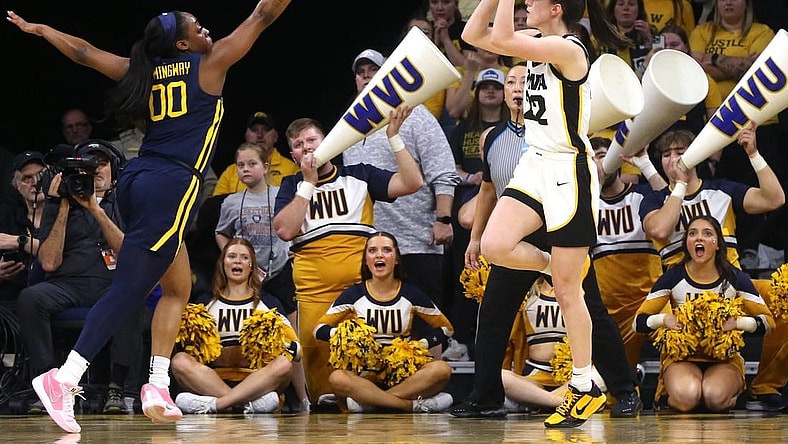 Iowa’s Caitlin Clark (22) shoots as West Virginia’s Jayla Hemingway (00) defends in a NCAA Tournament round of 32 game Monday, March 25, 2024 at Carver-Hawkeye Arena in Iowa City, Iowa.