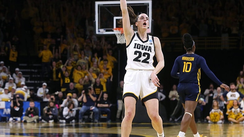 Iowa’s Caitlin Clark (22) holds a pose as she celebrates a made 3-point basket against West Virginia in a NCAA Tournament round of 32 game Monday, March 25, 2024 at Carver-Hawkeye Arena.