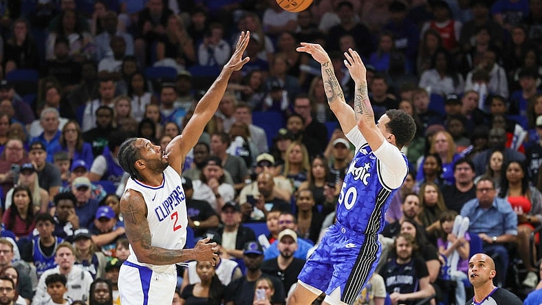 Mar 29, 2024; Orlando, Florida, USA; Orlando Magic guard Cole Anthony (50) shoots the ball over LA Clippers forward Kawhi Leonard (2) during the second half at KIA Center. Mandatory Credit: Mike Watters-USA TODAY Sports