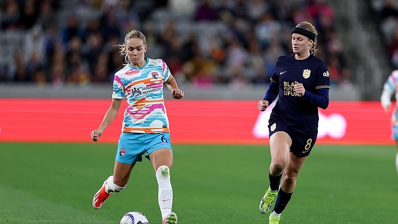 Mar 29, 2024; San Diego, California, USA; San Diego Wave FC defender Hanna Lundkvist (6) kicks the ball as Seattle Reign FC forward Bethany Balcer (8) defends during the second half at Snapdragon Stadium. Mandatory Credit: Abe Arredondo-USA TODAY Sports