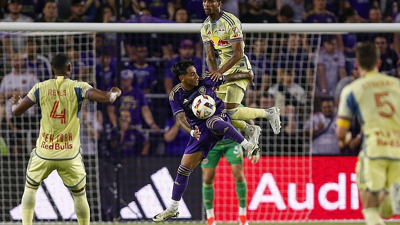 Mar 30, 2024; Orlando, Florida, USA; Orlando City midfielder Facundo Torres (10) and New York Red Bulls defender Kyle Duncan (6) battle for the ball during the first half at Inter&Co Stadium. Mandatory Credit: Russell Lansford-USA TODAY Sports