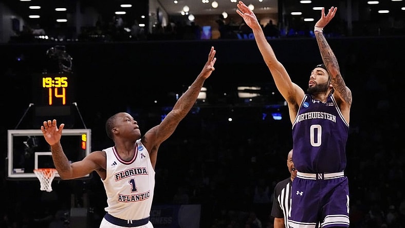 March 22, 2024, Brooklyn, NY, USA; Northwestern Wildcats guard Boo Buie (0) shoots over Florida Atlantic Owls guard Johnell Davis (1) in the first round of the 2024 NCAA Tournament at the Barclays Center. Mandatory Credit: Robert Deutsch-USA TODAY Sports